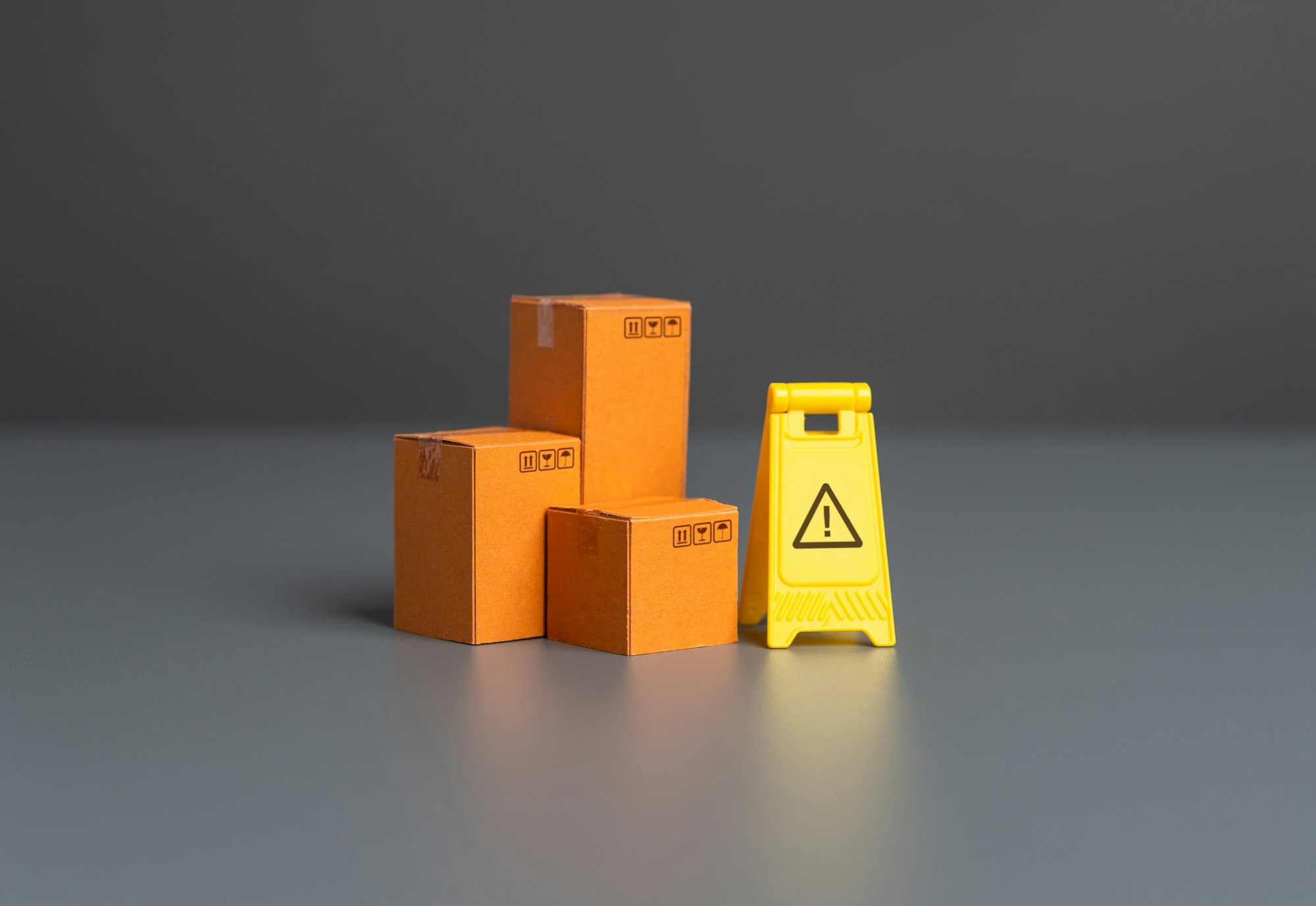 Boxes and warning sign. Restrictions on trade, import and export of goods.